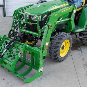 AV20 Root Grapple on a 300E Loader attached to a compact utility tractor