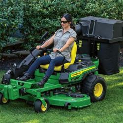 Person mowing lawn using a Z325E with a bagger attached